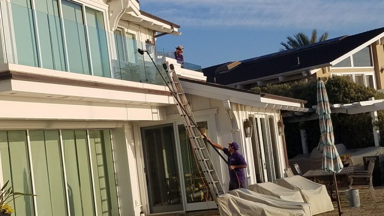Cleaning the windows in a beautiful home in Orange County ca